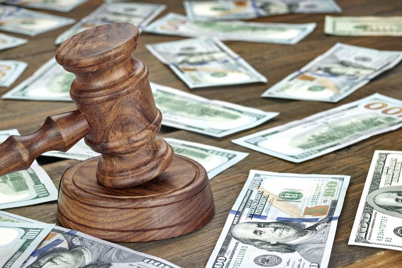 Judge's gavel and money on a table.