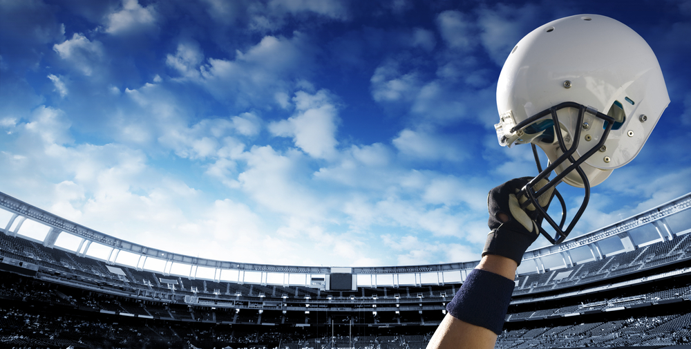 american-football-helmet-raised-in-the-air-inside-football-ground