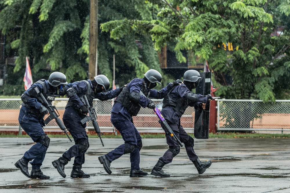 armed police officer in uniform during a raid