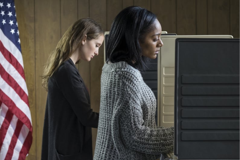 Two women voting at a polling place